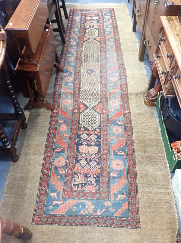 A CARPET RUNNER, WITH MOTIFS WITH REPEAT BORDERS