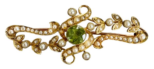 AN ANTIQUE EDWARDIAN PERIDOT AND SEED PEARL BROOCH