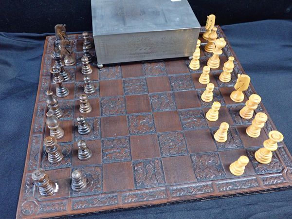 A CARVED WOODEN CHESS BOARD