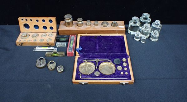 A SET OF GLASS METRIC WIGHTS, BRASS WEIGHTS