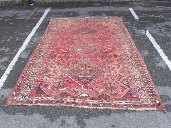 A TURKISH RUG, WORKED IN REDS