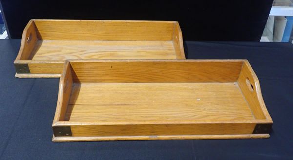 A PAIR OF EARLY 20th CENTURY BRASS-BOUND LIGHT OAK BOOK TROUGHS