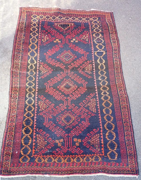 A SMALL TRIBAL RUG, DARK BLUE GROUND