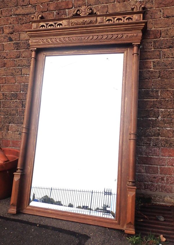 A VICTORIAN OAK AND PARCEL-GILT WALL MIRROR