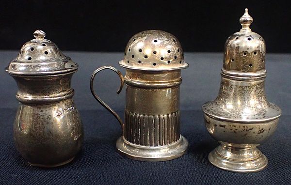 A GROUP OF THREE SILVER PEPPER POTS