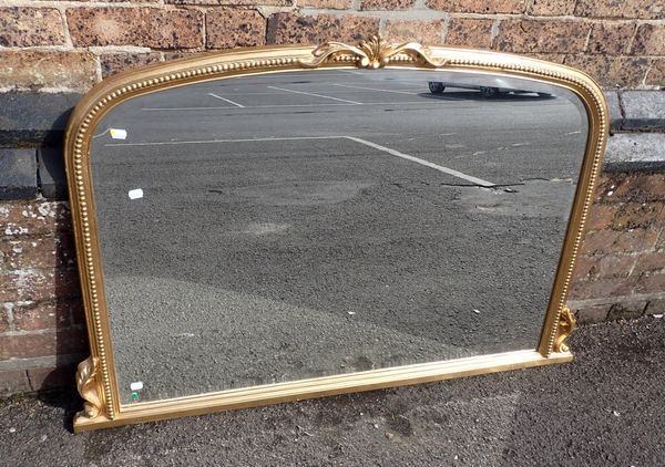 A GILT FRAMED OVERMANTEL MIRROR