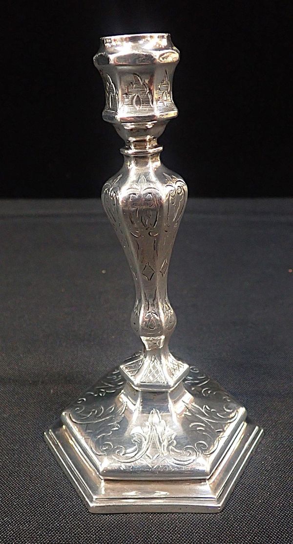 A SMALL WHITE METAL CANDLESTICK