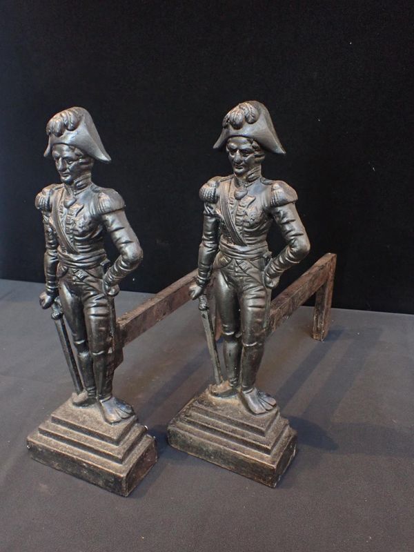 A PAIR OF CAST IRON FIRE DOGS