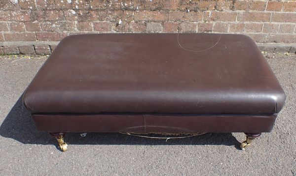 A LEATHER-COVERED FOOTSTOOL