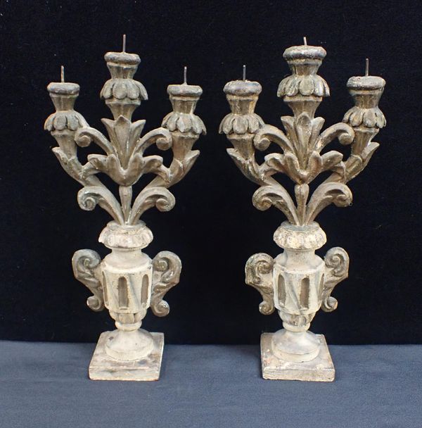 A PAIR OF CONTINENTAL CARVED GILTWOOD CANDELABRA