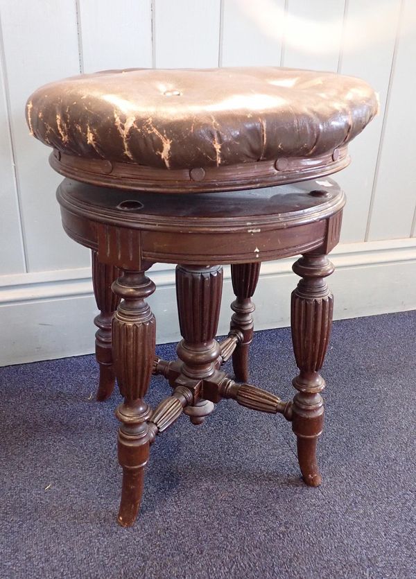 A VICTORIAN MAHOGANY REVOLVING PIANO STOOL WITH REEDED LEGS