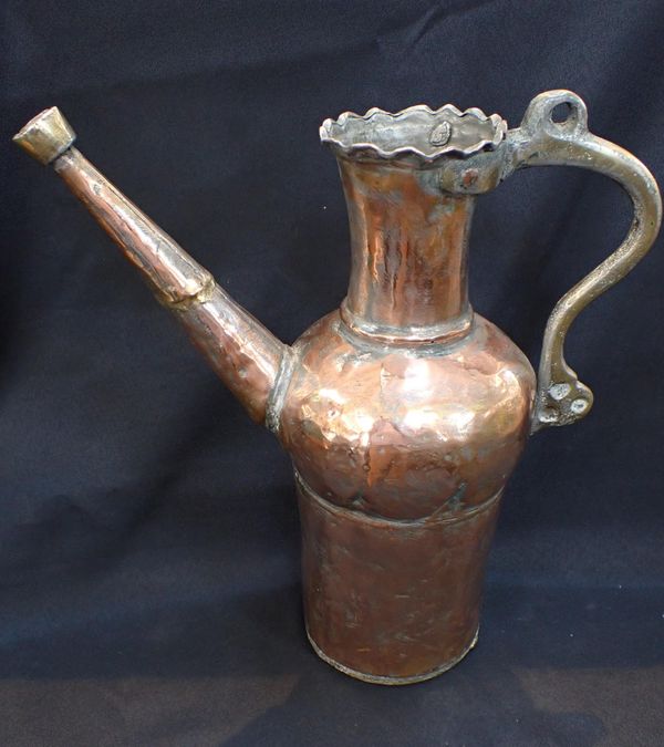 A MIDDLE EASTERN COPPER AND BRASS EWER