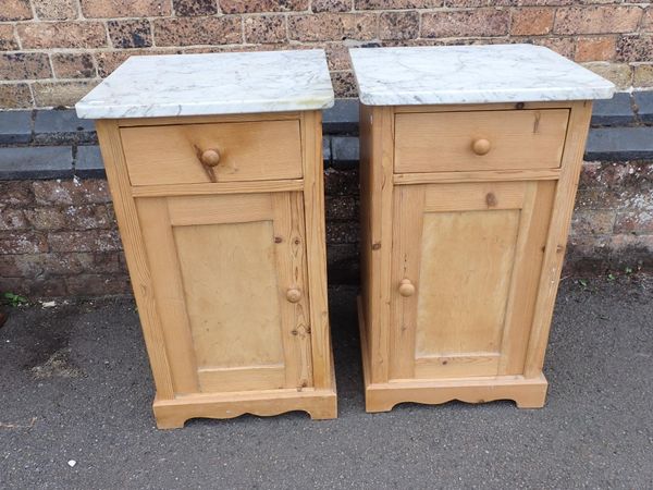 A PAIR OF STRIPPED PINE BEDSIDE CUPBOARDS