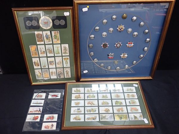A FRAMED DISPLAY OF VARIOUS FIRE BRIGADE BADGES AND BUTTONS