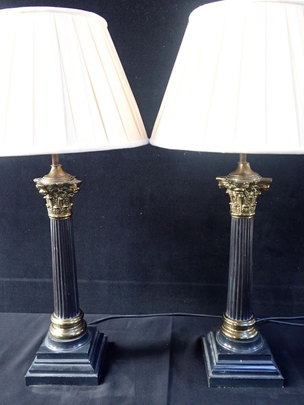 A PAIR OF PATINATED METAL AND BRASS CORINTHIAN COLUMN TABLE LAMPS