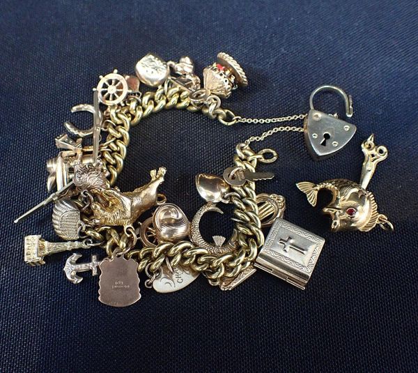 A GILT METAL CHARM BRACELET