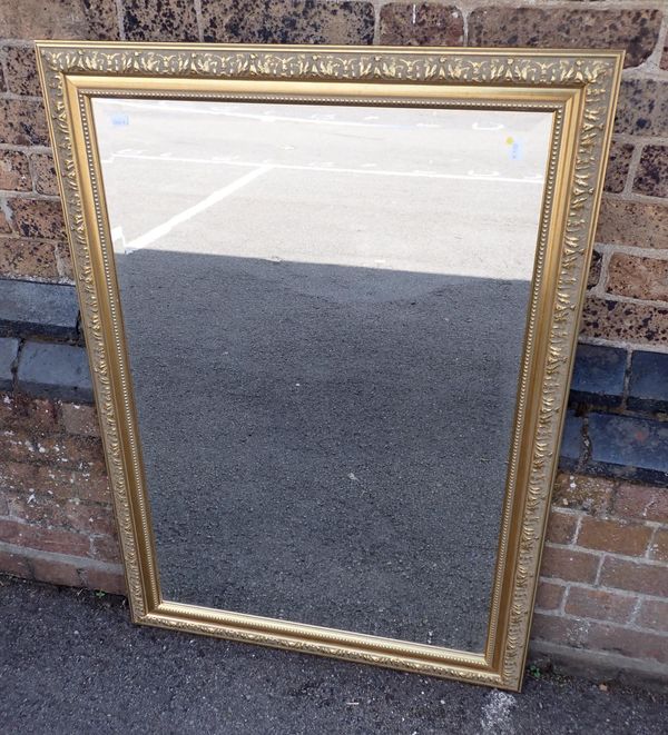 A GILT FRAME MIRROR WITH BEVELLED GLASS