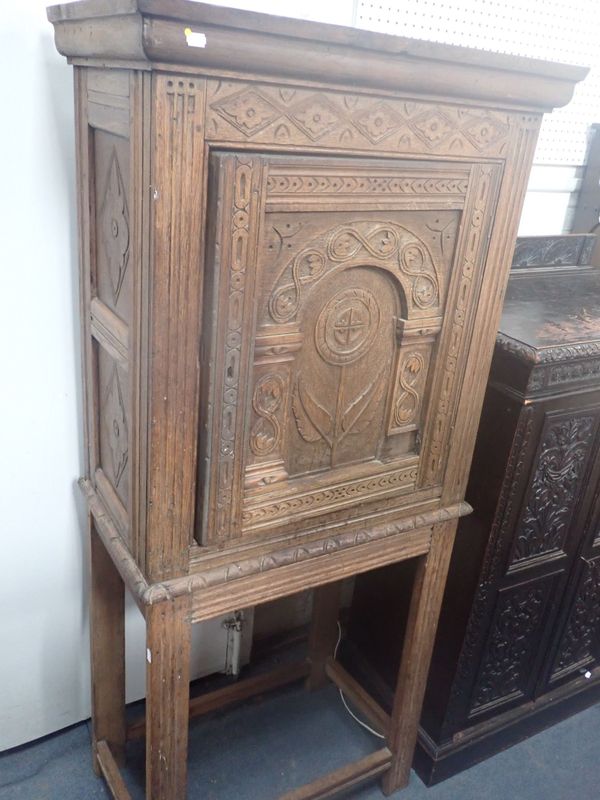 AN OAK CUPBOARD ON STAND