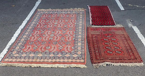 A RED GROUND BOKHARA PRAYER RUG