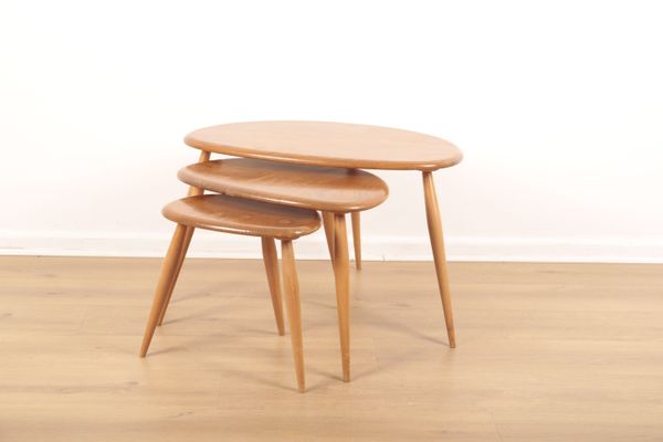 ERCOL MODEL 354: A NEST OF ELM AND BEECH PEBBLE TABLES