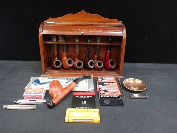 A MAHOGANY PIPE RACK WITH TAMBOUR FRONT