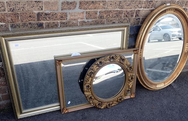 A GILT FRAMED OVAL MIRROR