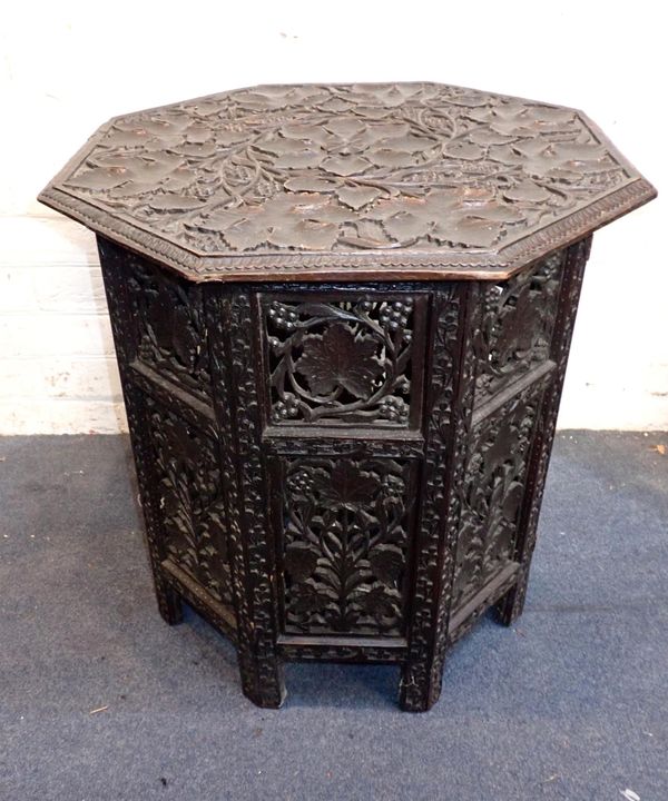 AN INDIAN CARVED HARDWOOD FOLDING OCTAGONAL TABLE