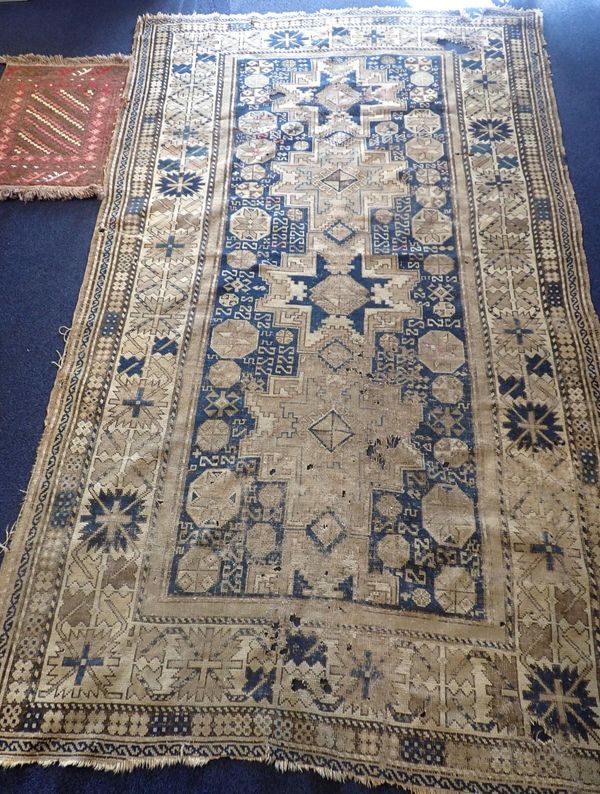 AN OLD BLUE GROUND RUG