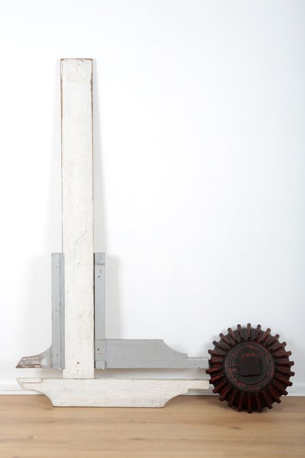 A LARGE CARVED WOODEN COG ADVERTISING SIGN