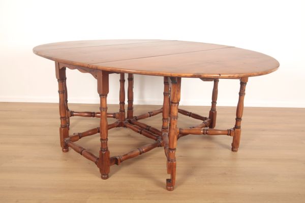 A YEW WOOD OVAL GATELEG TABLE