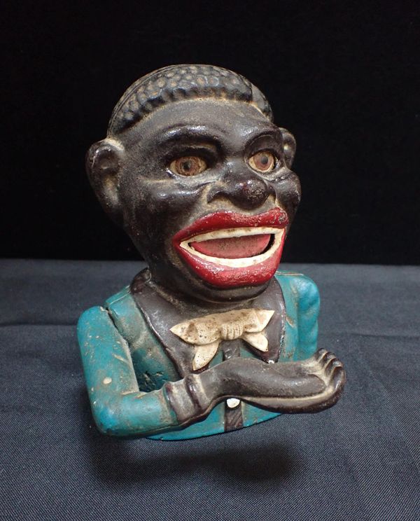 A CAST IRON NOVELTY MONEY BOX