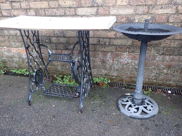 A CAST IRON SEWING MACHINE BASE