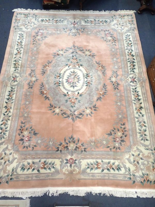 A LARGE CHINESE PINK GROUND RUG