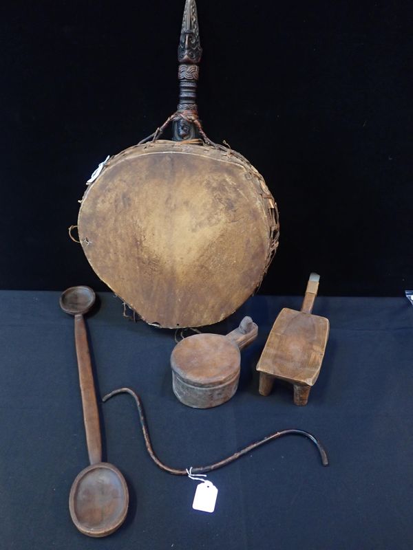 A TRIBAL DRUM WITH CARVED HANDLE