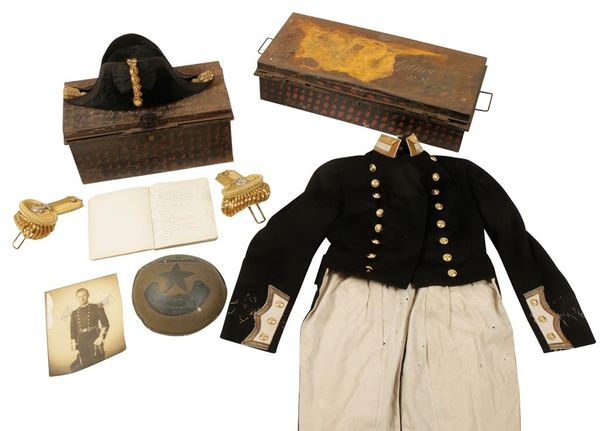 A ROYAL NAVY TAIL COAT, COCKED HAT, EPAULETS AND NOTEBOOK