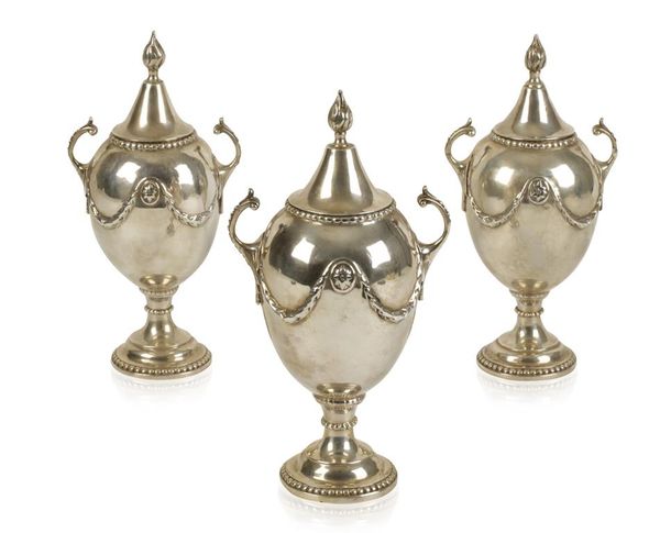 A SET OF THREE GEORGE III SILVER CONDIMENT VASES AND COVERS