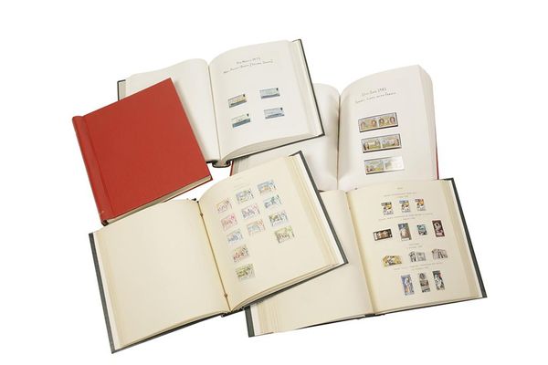 FOUR METICULOUSLY HAND ANNOTATED ALBUMS WITH STAMPS OF THE WORLD