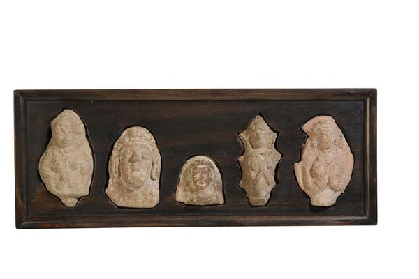 FRAMED GROUP OF FIVE INDIAN VOTIVE TERRACOTTA HEADS