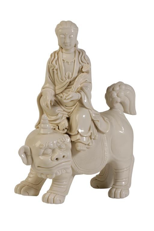 BLANC DE CHINE FIGURE OF GUANYIN SEATED ATOP A BUDDHIST LION