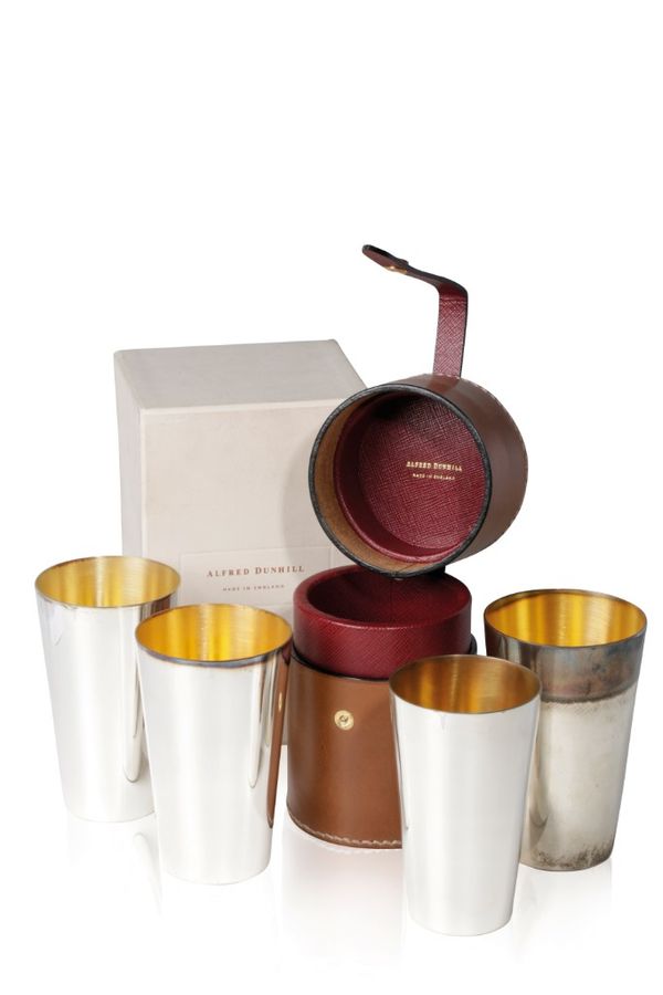 ALFRED DUNHILL: A SET OF FOUR GRADUATED SILVER AND PARCEL-GILT BEAKERS