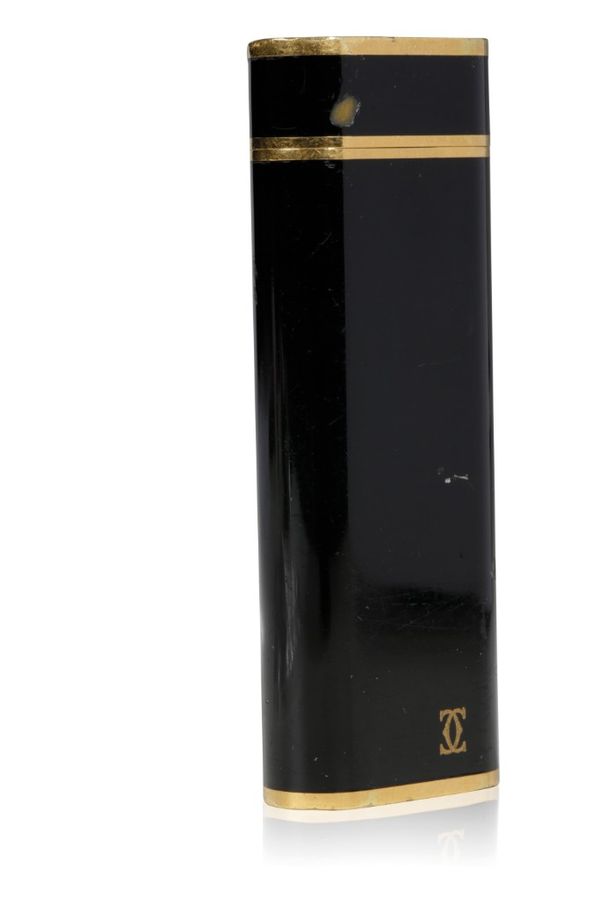 CARTIER: A BLACK LACQUER AND GOLD PLATED CIGARETTE LIGHTER