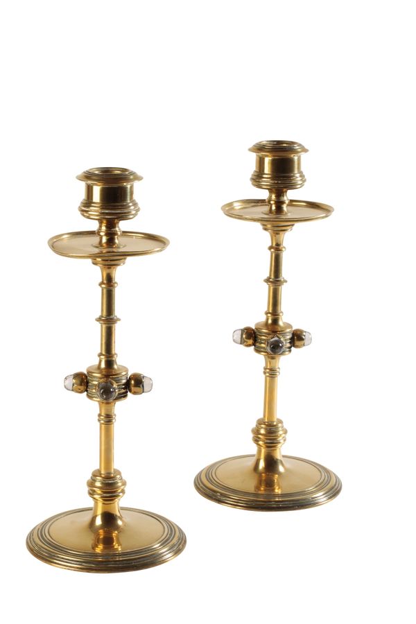 IN THE MANNER OF A.W.N PUGIN: A PAIR OF AESTHETIC MOVEMENT BRASS CANDLESTICKS