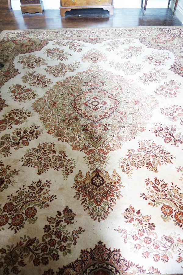 AN AXMINSTER TYPE PERSIAN STYLE CARPET