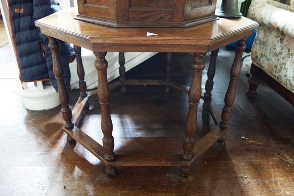 AN OCTAGONAL OAK CENTRE TABLE