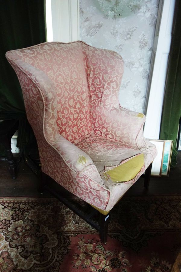 A GEORGE III MAHOGANY WINGBACK LIBRARY ARMCHAIR