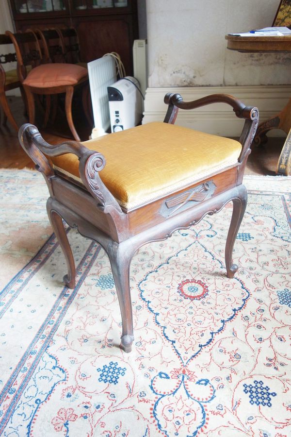 AN EDWARDIAN MAHOGANY PIANO STOOL