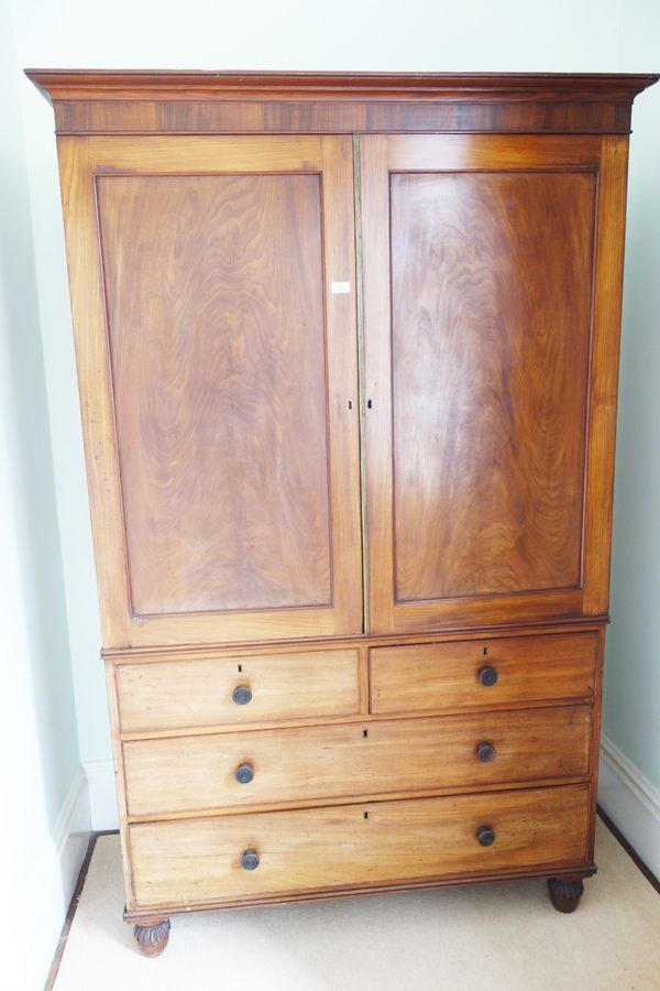 AN EARLY VICTORIAN MAHOGANY LINEN PRESS