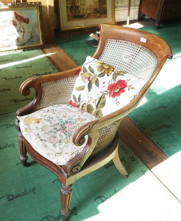 A LATE REGENCY MAHOGANY LIBRARY BERGERE ARMCHAIR