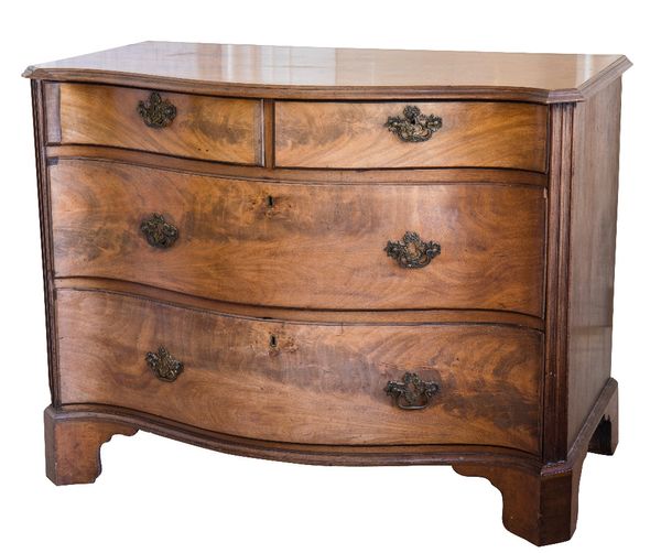 AN EARLY GEORGE III MAHOGANY SERPENTINE CHEST OF DRAWERS