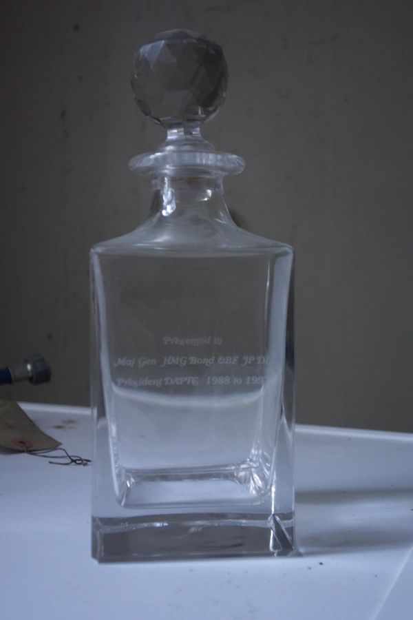 A CUBE-SHAPED GLASS DECANTER